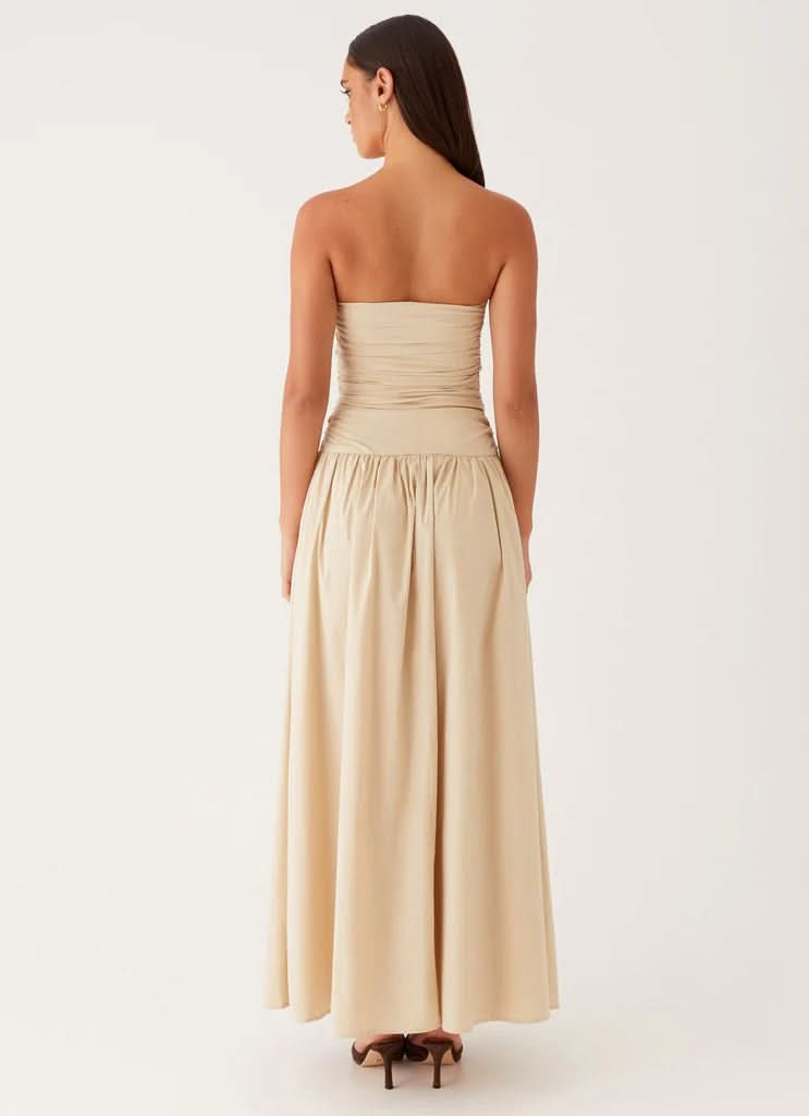 Back view cream strapless maxi dress with voluminous skirt