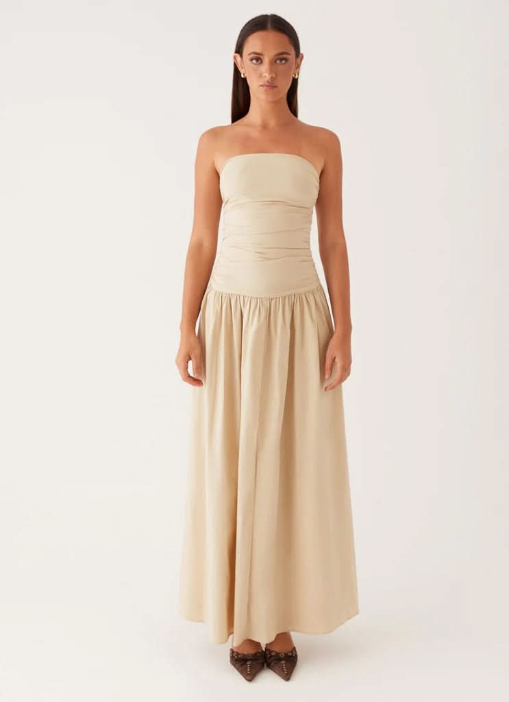 Front view cream strapless maxi dress with fitted ruched top