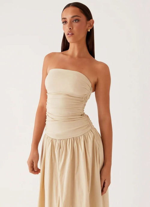 Cream strapless maxi dress with ruched waist and flowing skirt