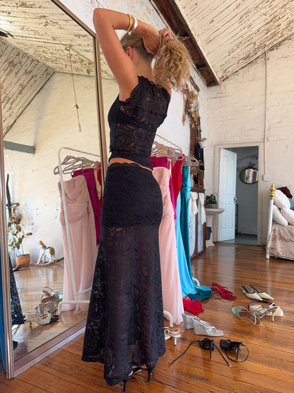 Black lace two-piece set back view showing fitted crop top and maxi skirt