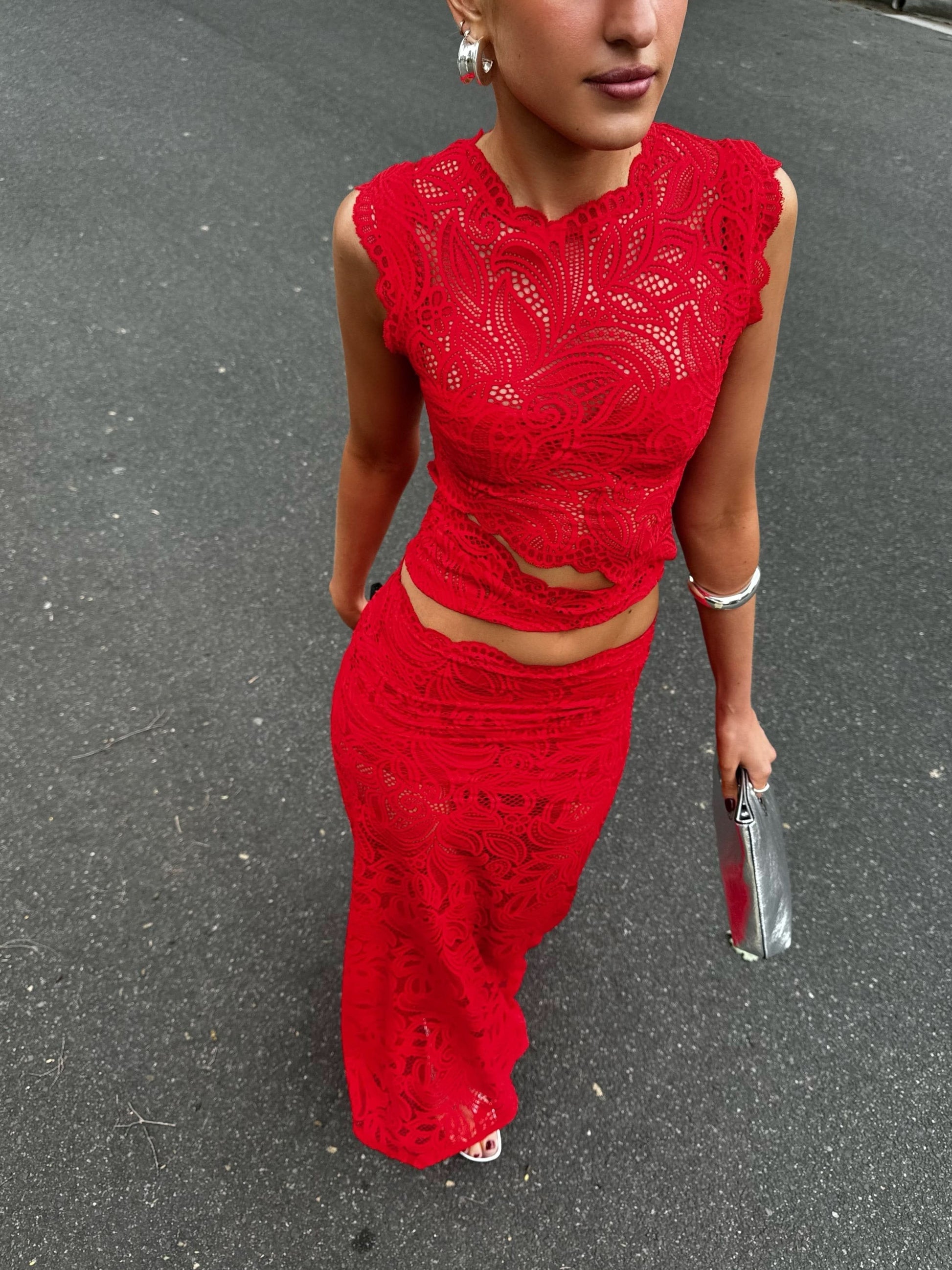 Red lace sleeveless crop top with intricate floral cutwork and scalloped neckline