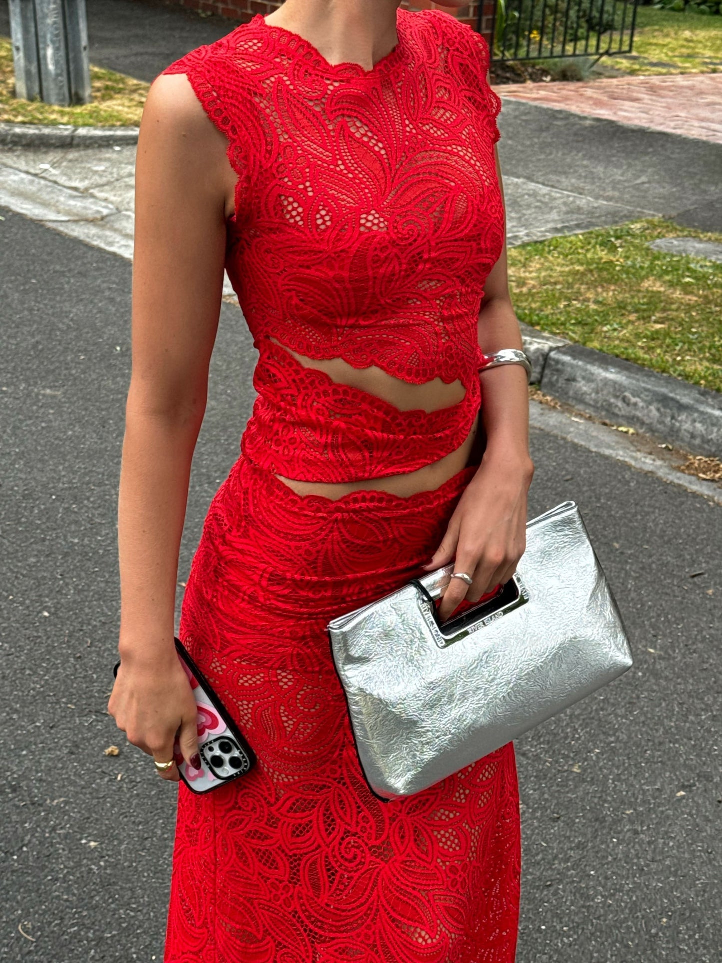 Red lace sleeveless crop top and midi skirt set with cutout waist detail