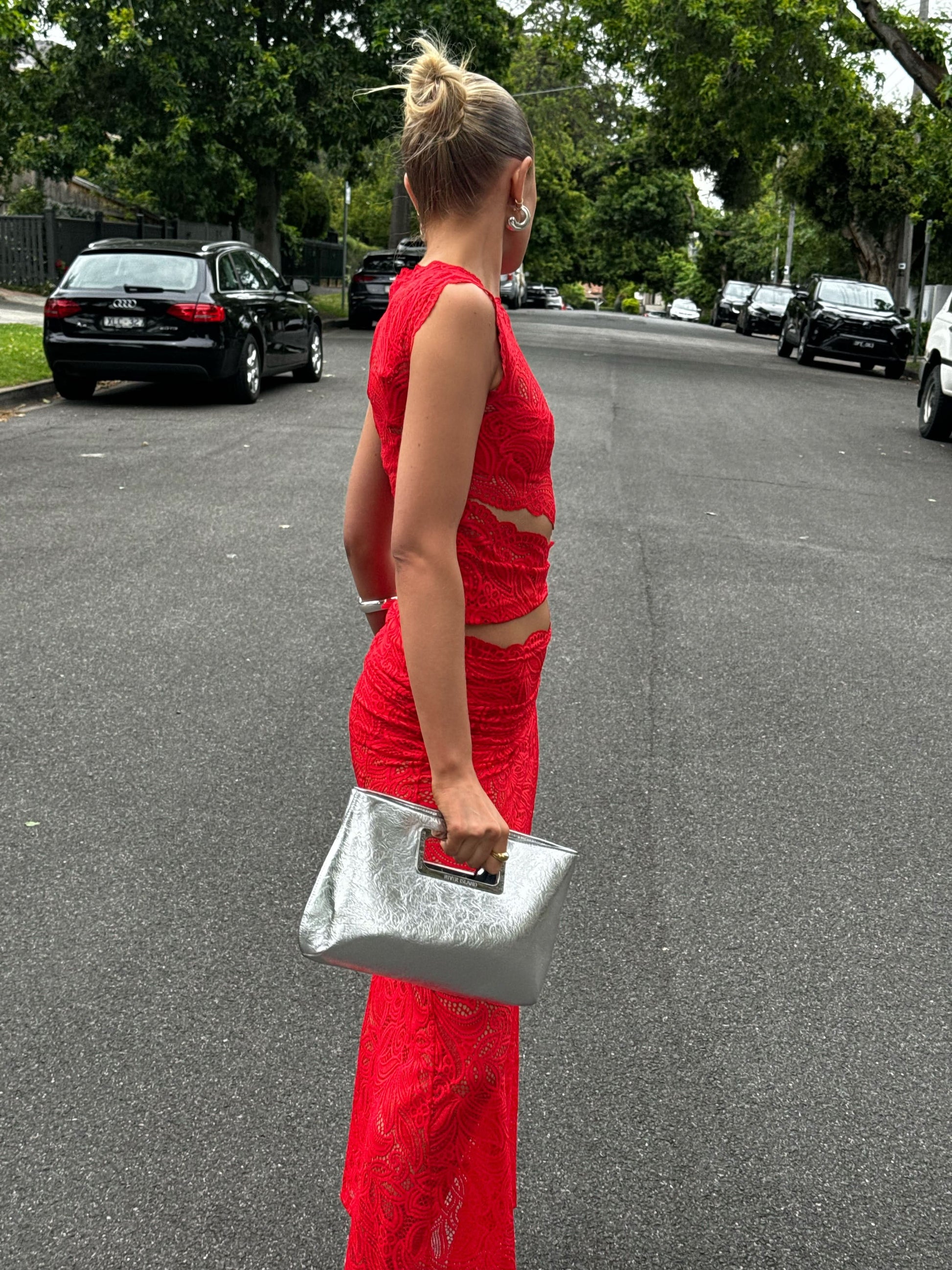 Red lace two-piece set side view showing fitted crop top and maxi skirt silhouette