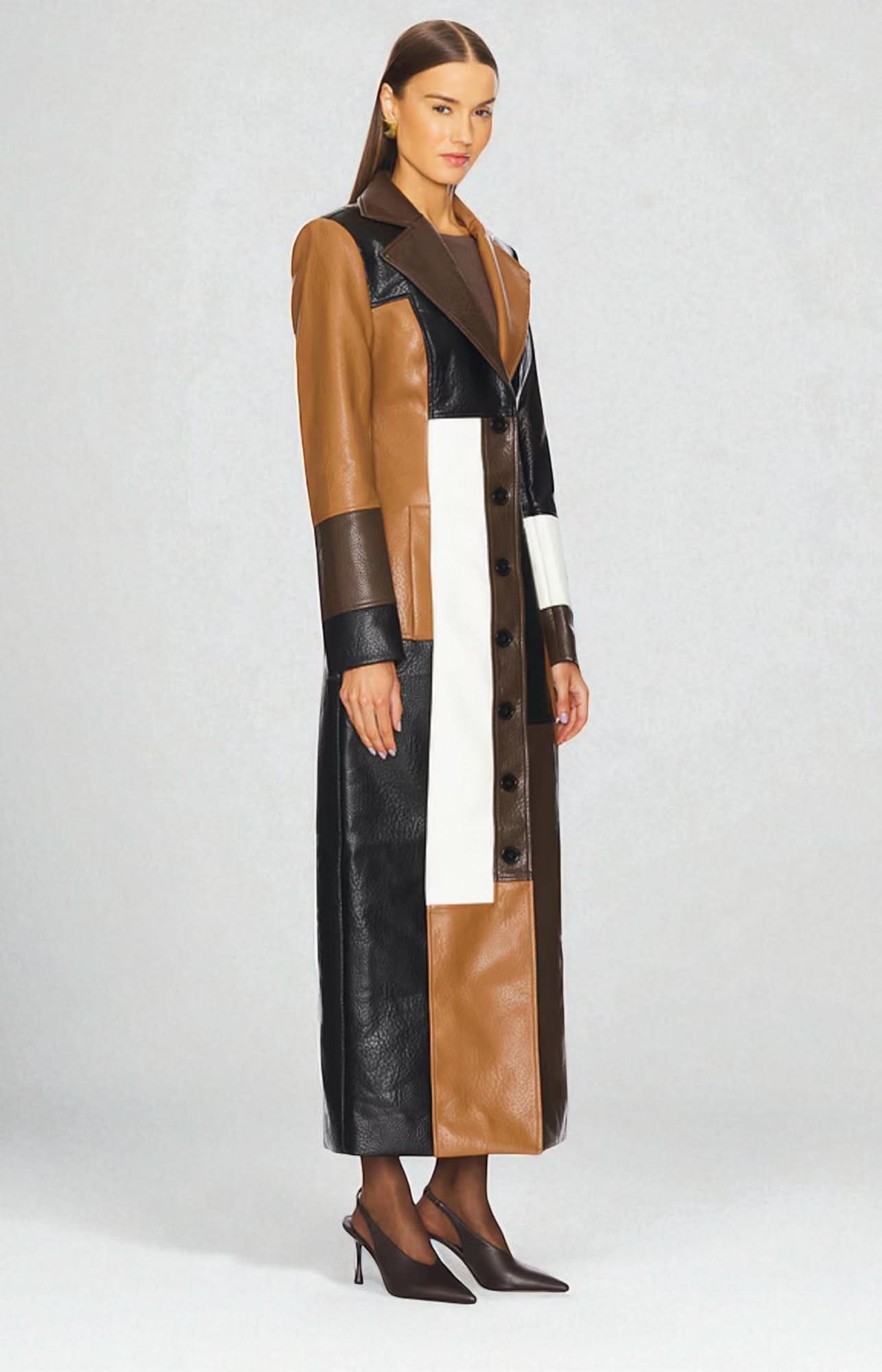 Side view of women's brown and camel leather maxi coat showing geometric color-blocking detail