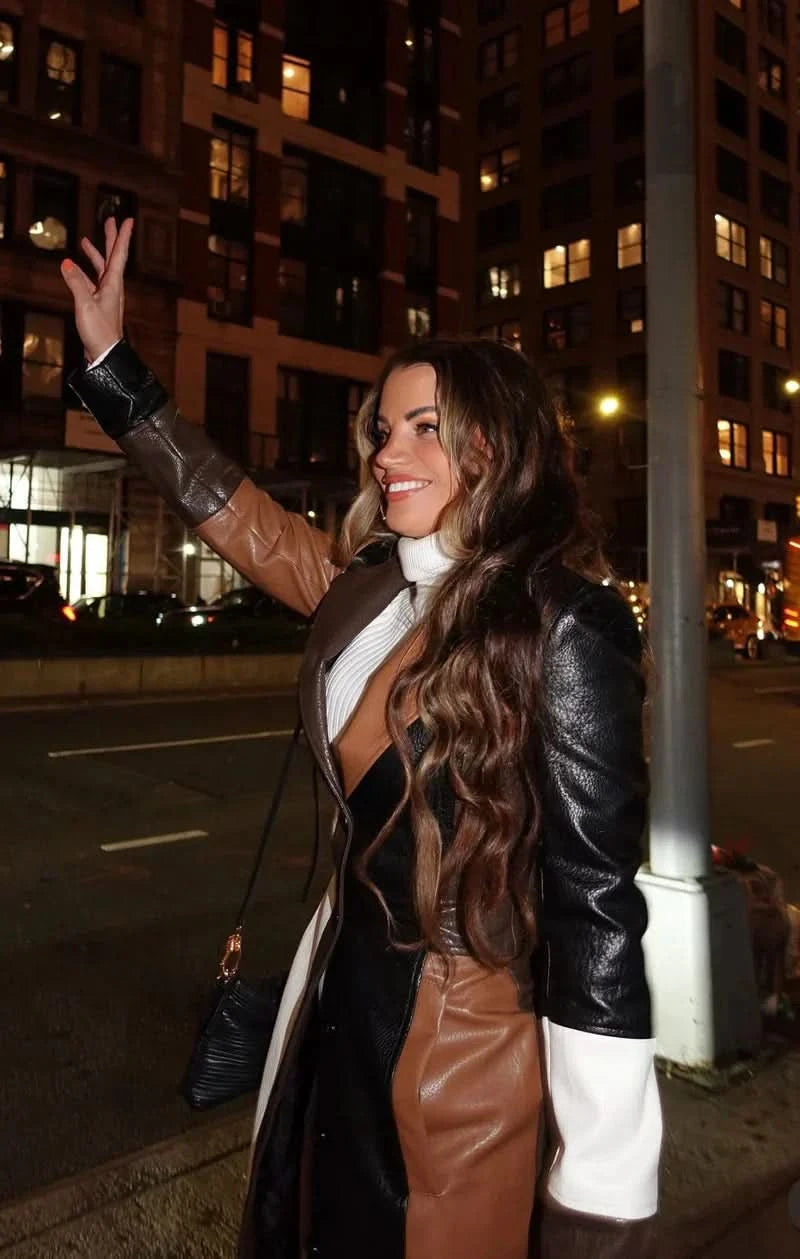 Women wearing camel leather color-block maxi coat styled for evening downtown setting
