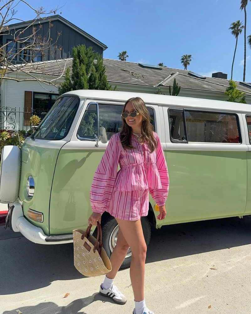 Woman in pink striped lounge set demonstrating versatile casual wear styling