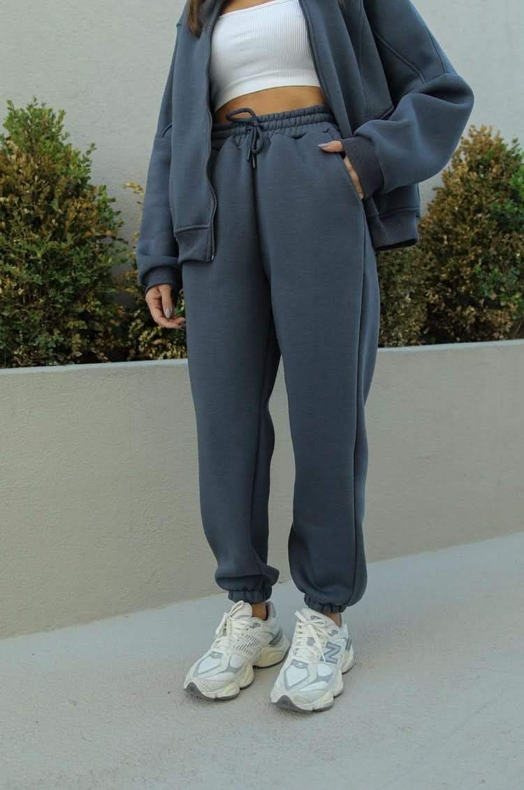 Gray athletic tracksuit pants with drawstring waist and ribbed cuffs