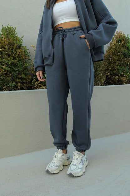 Gray athletic tracksuit pants with drawstring waist and ribbed cuffs