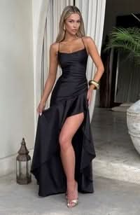Black satin maxi dress with fitted bodice and asymmetrical draped skirt