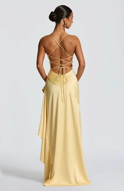 Rear view of pale yellow maxi dress with crossback straps and flowing train
