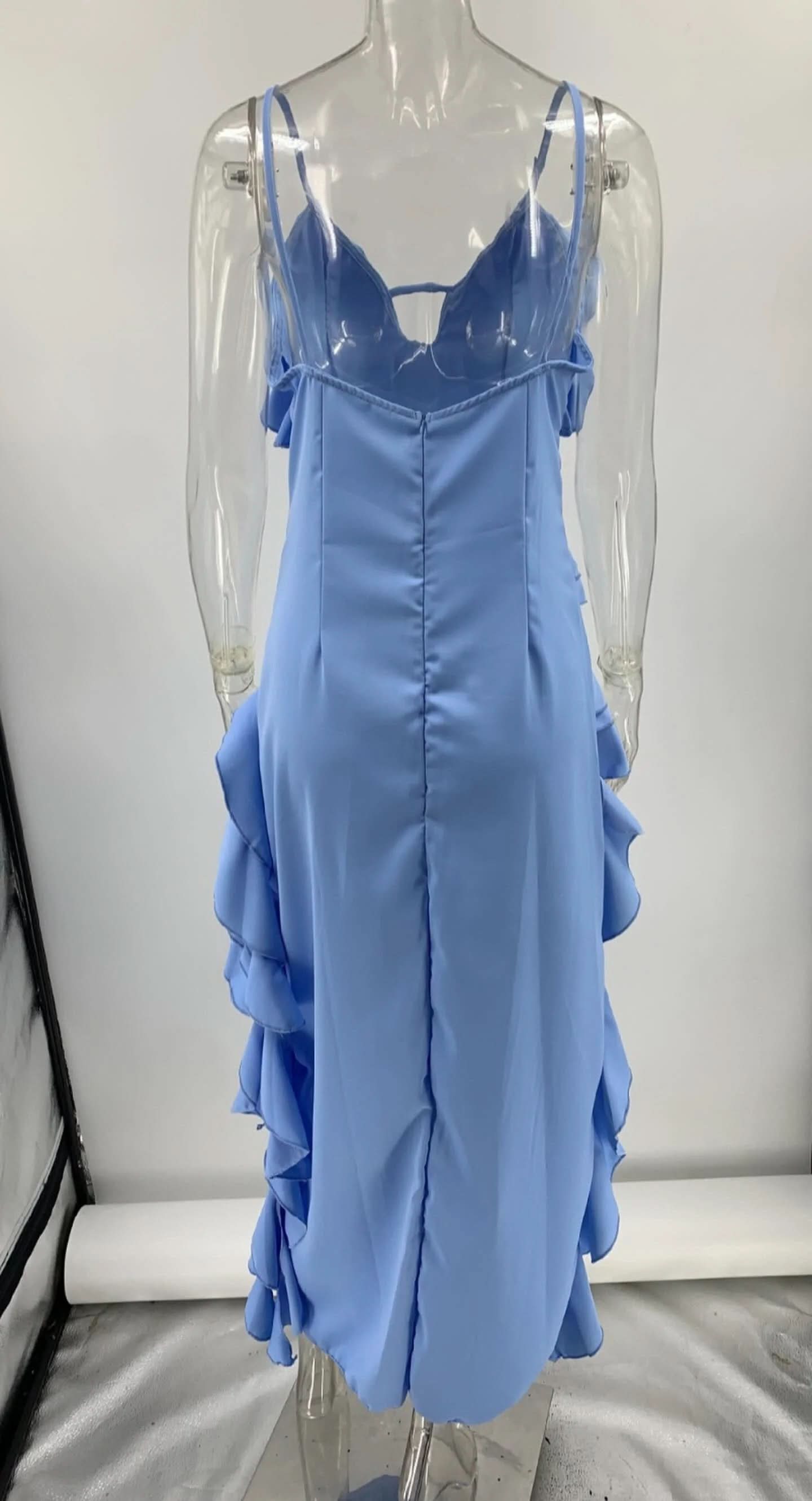 Back mannequin view of periwinkle maxi dress with flowing ruffled layers