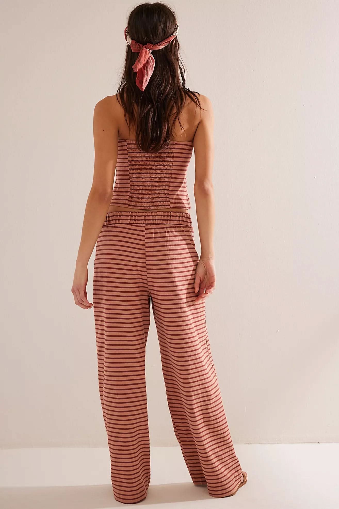 Back view of coral and white striped halter crop top and pants set