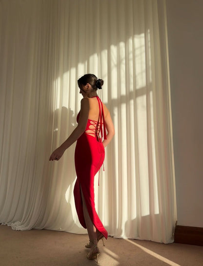 Red halter maxi dress with lace-up back detail and high slit