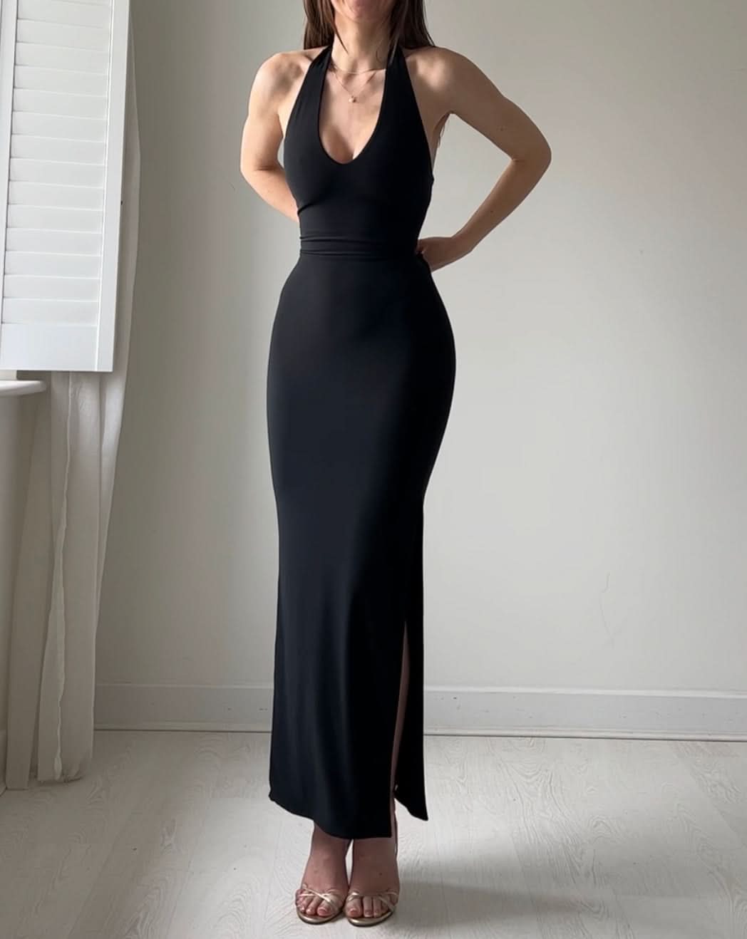 Black halter maxi dress with ruched waist and front slit