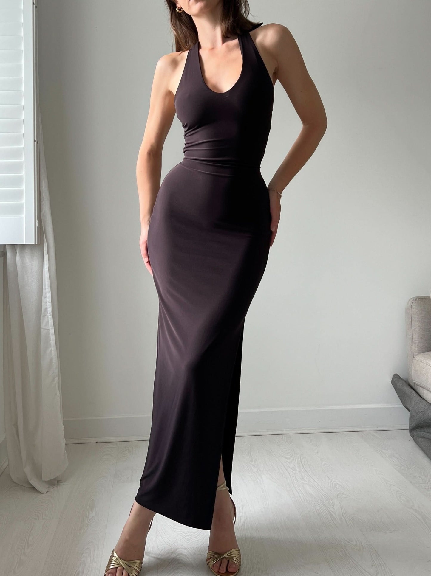 Black halter maxi dress with high leg slit and fitted bodice