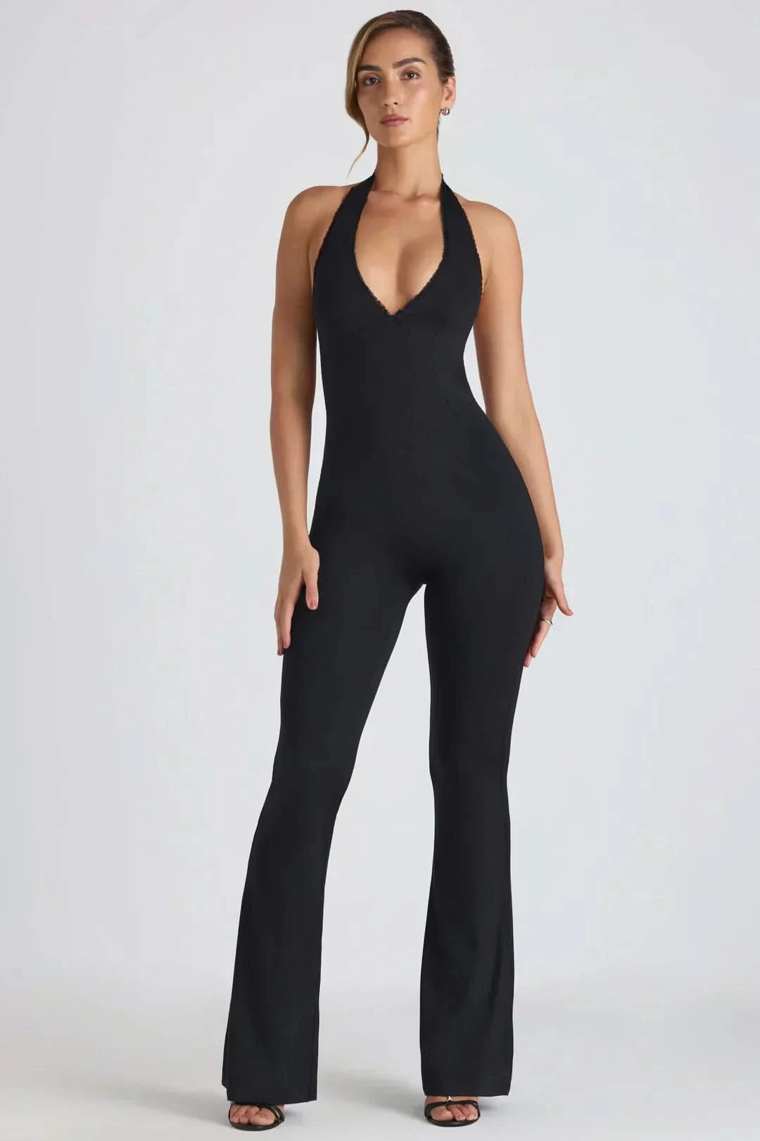 Black halter flared jumpsuit with V-neckline and wide-leg pants silhouette