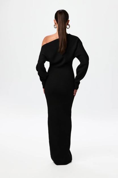 Back view of black off-shoulder knit maxi dress showing draped neckline