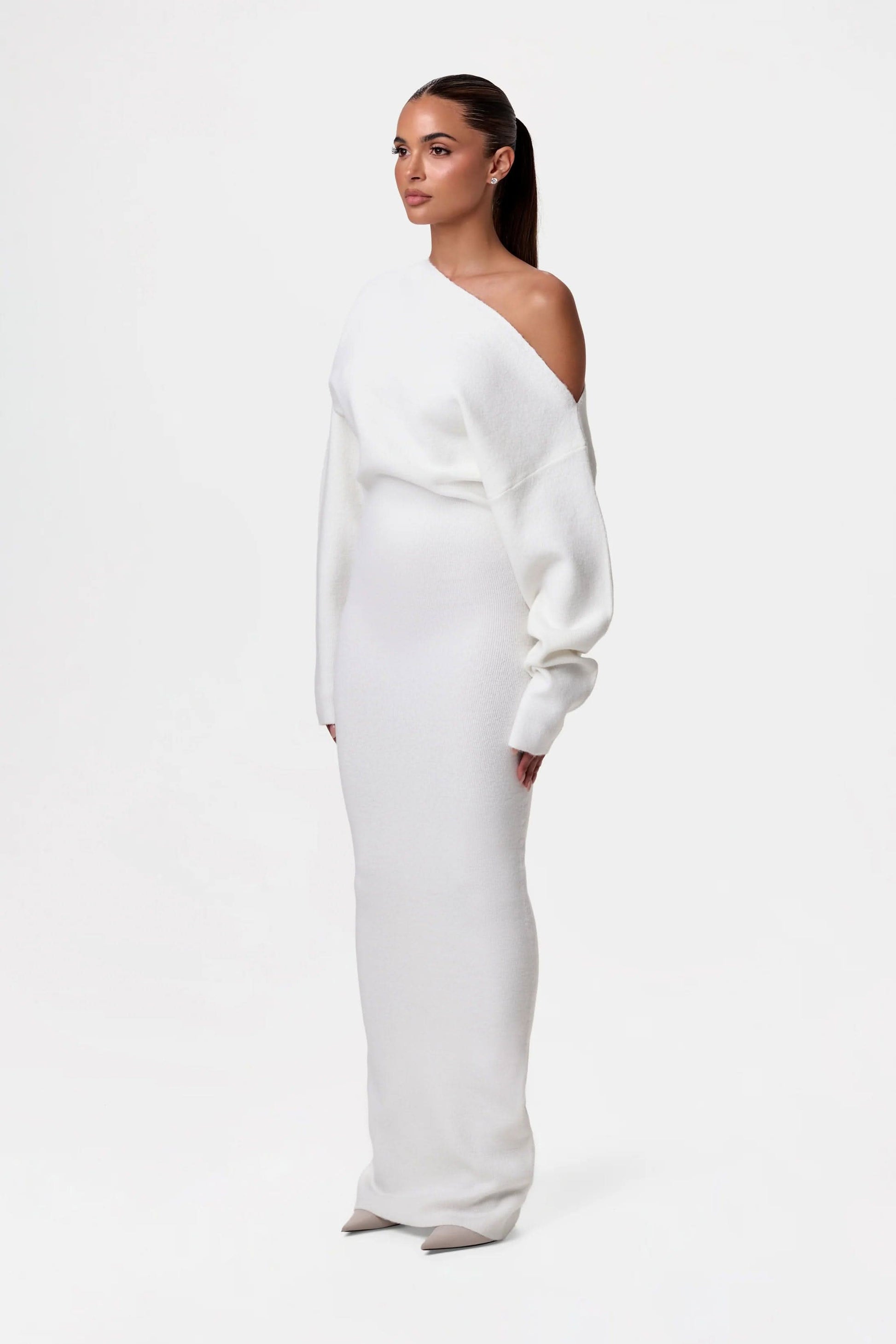 Back view of black off-shoulder knit maxi dress showing draped neckline