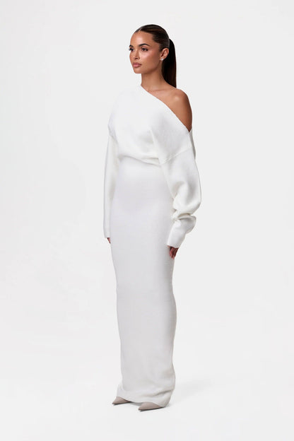 Back view of black off-shoulder knit maxi dress showing draped neckline