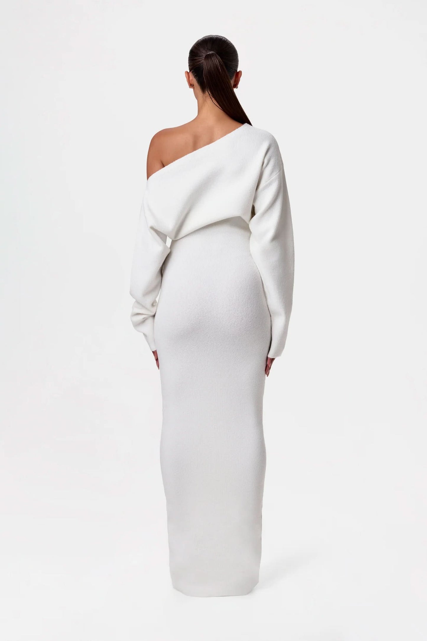 Back view of white off-shoulder knit maxi dress with draped shoulder detail