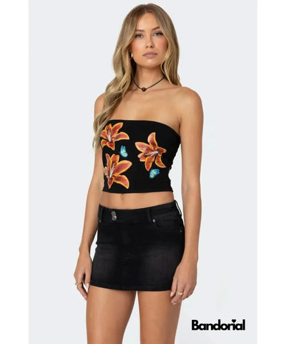 Black bandeau tube top with vibrant orange lily print and blue butterfly accents
