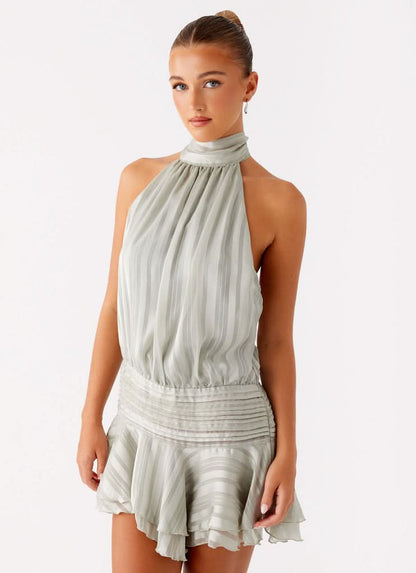 Front view of sage green pleated halter chiffon mini dress with gathered bodice