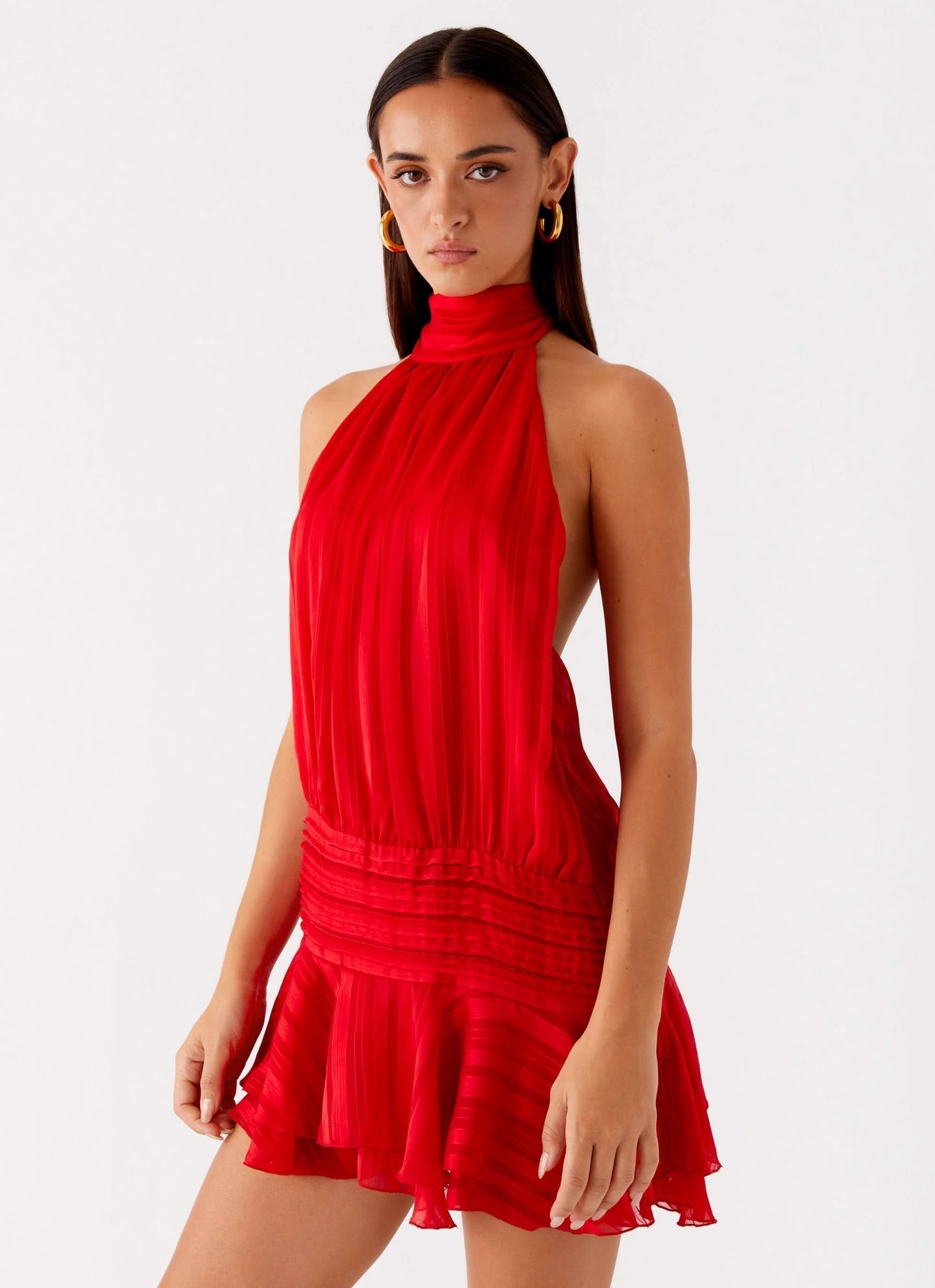 Red pleated chiffon halter mini dress with ruched bodice and tiered skirt