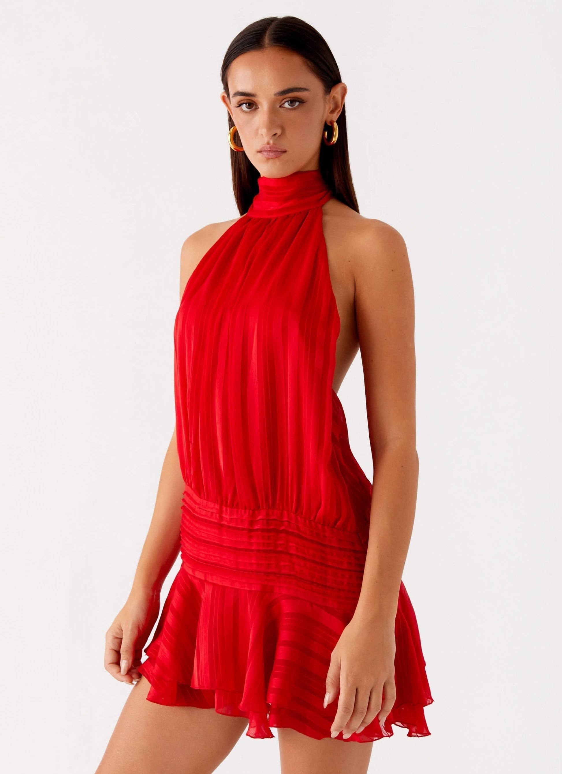 Red pleated chiffon halter mini dress with ruched bodice and tiered skirt