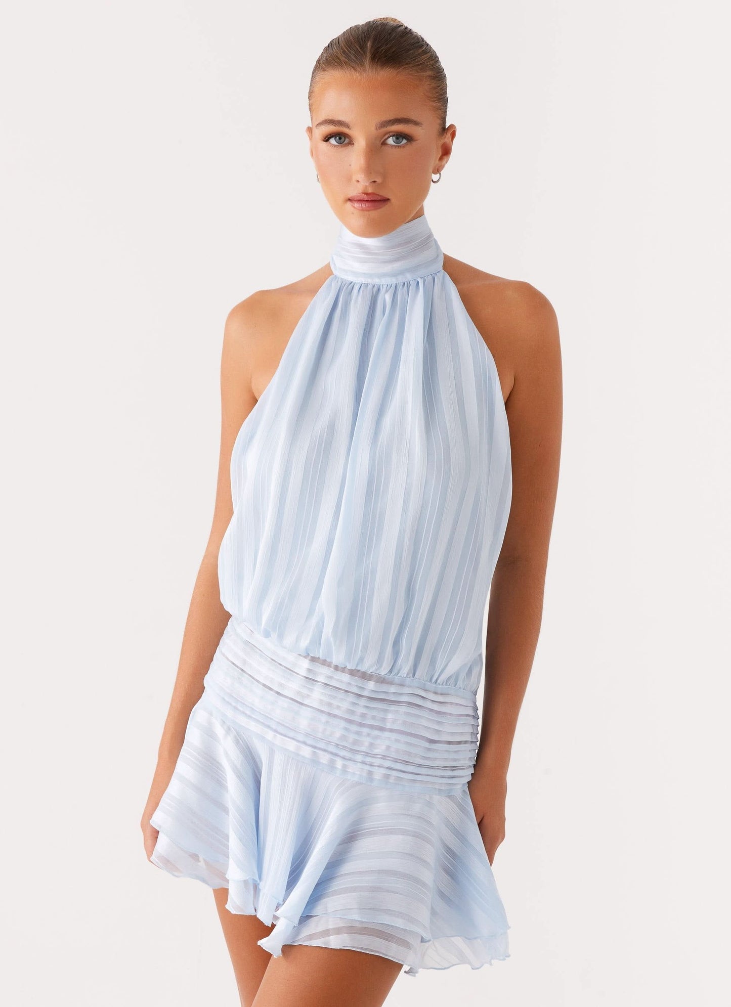 Front view of pale blue pleated halter chiffon mini dress with gathered neckline