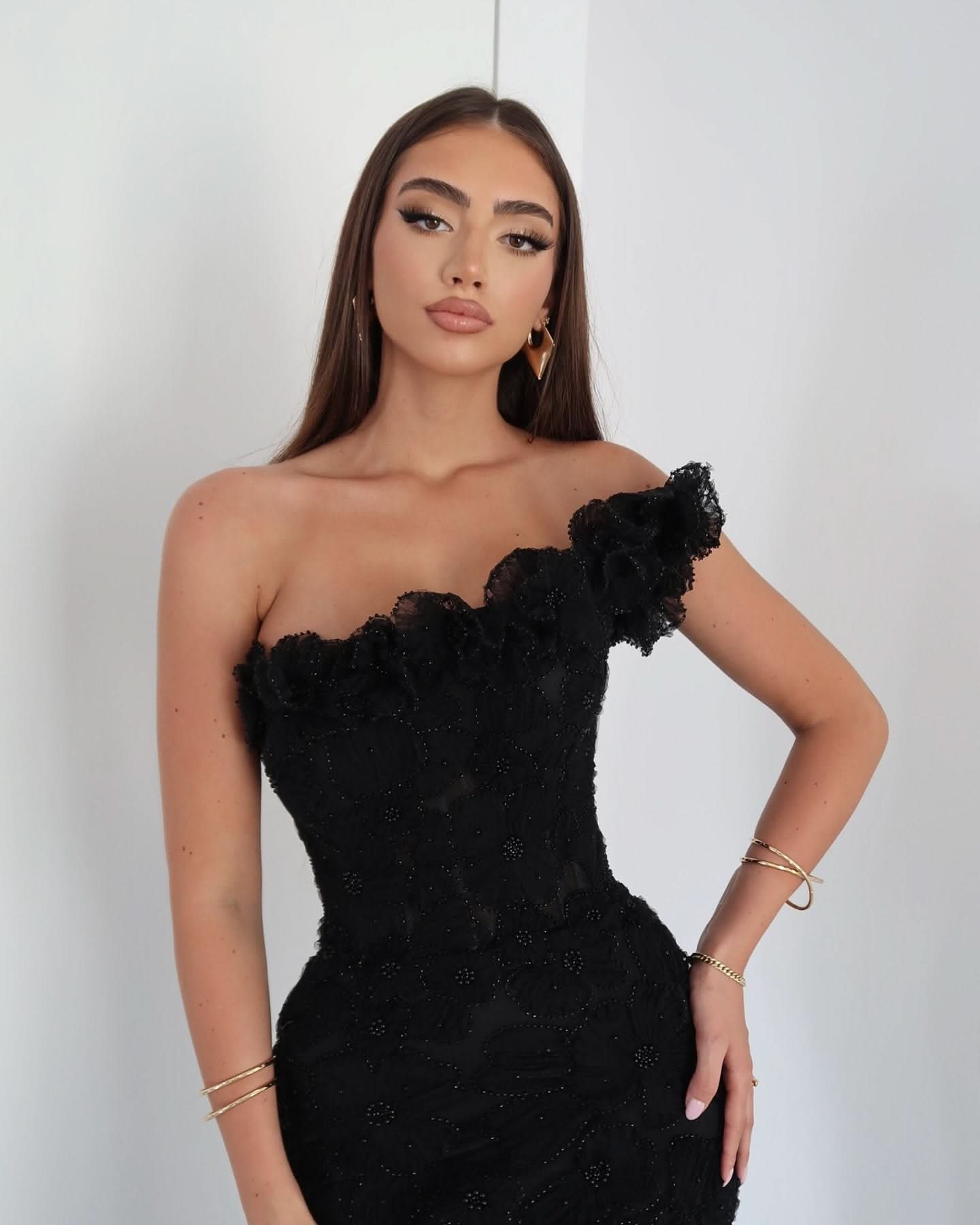 Black beaded maxi evening gown with asymmetrical neckline and intricate beading