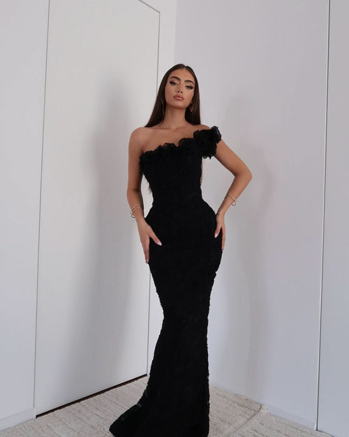 Black beaded asymmetrical off-shoulder maxi evening gown with sculpted silhouette