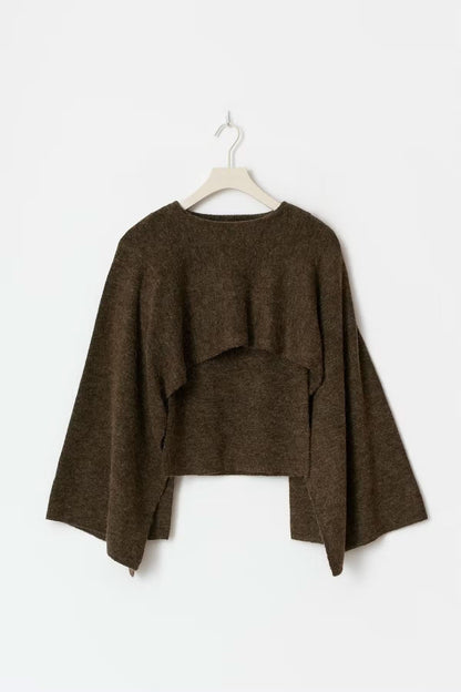 Olive knitted cape top flat lay on hanger showing cropped length and cape construction