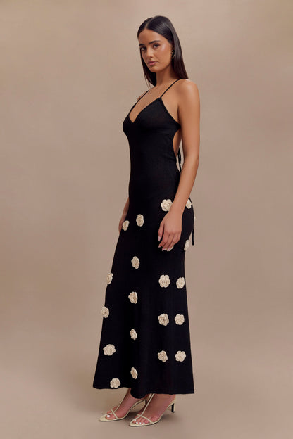 Black cami maxi dress with cream floral embellishments, side view