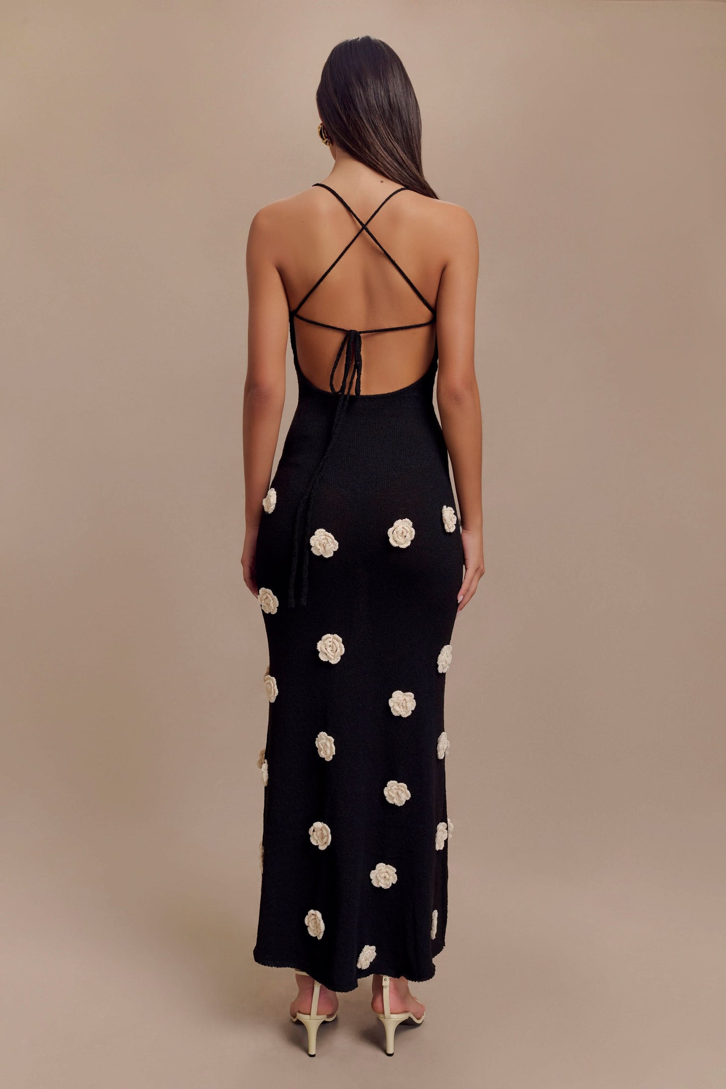 Back view of black maxi dress with crossback tie closure