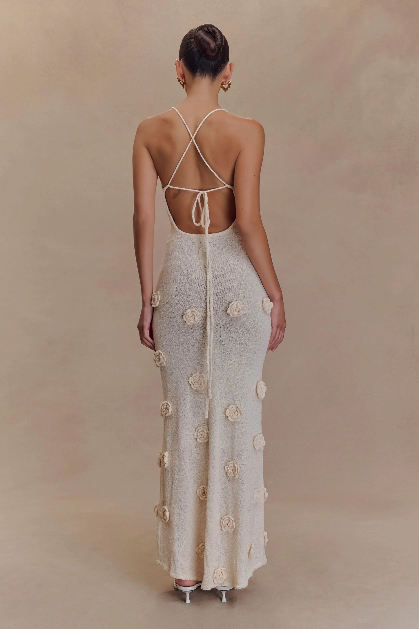 Back view of cream maxi dress with crossback straps and flowers