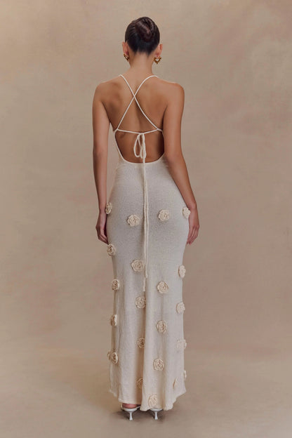 Back view of cream maxi dress with crossback straps and flowers