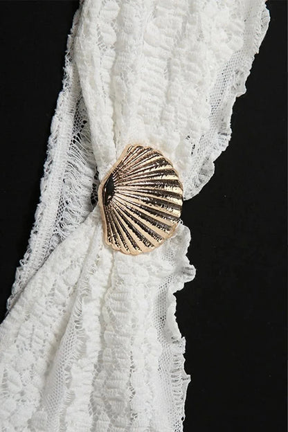 Gold shell buckle closure on white textured two-piece swimwear set