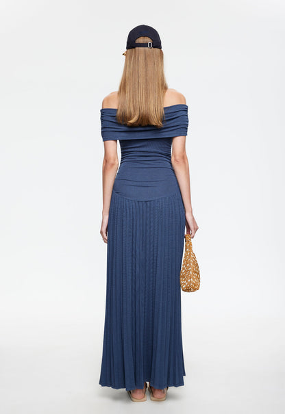 Back view of navy off-shoulder maxi dress with pleated floor-length skirt