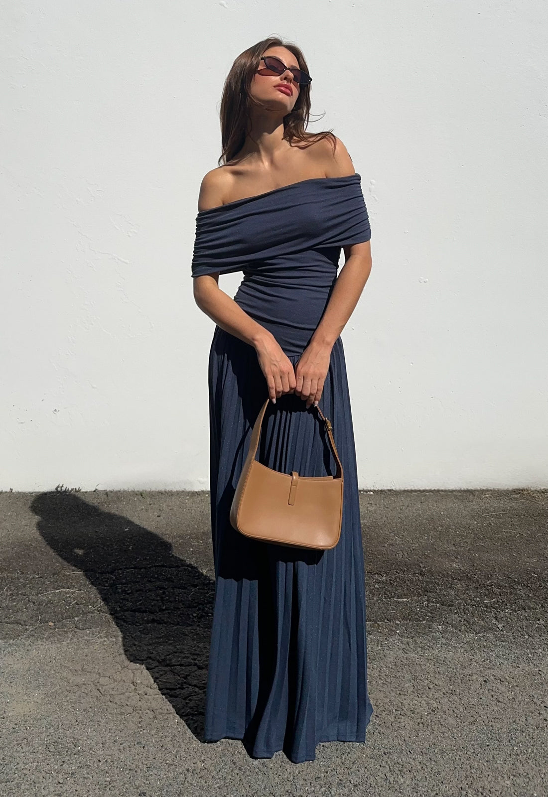 Navy off-shoulder maxi dress with gathered neckline and pleated skirt detail