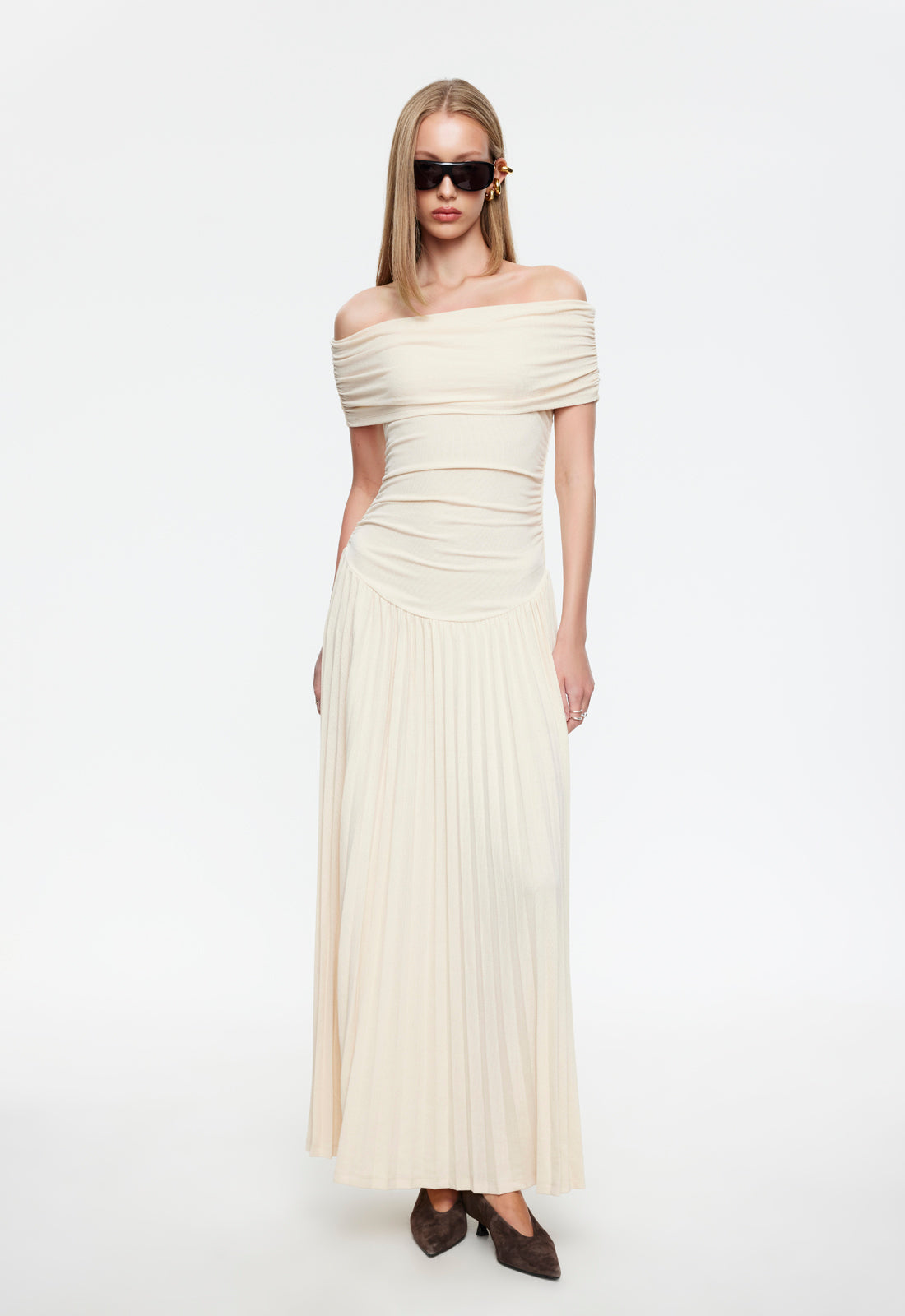Cream off-shoulder maxi dress with ruched bodice and pleated skirt
