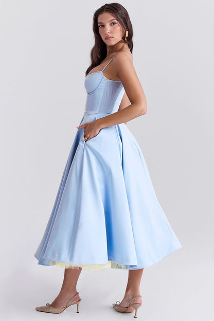 Side view of light blue midi dress showing fitted bodice and full skirt