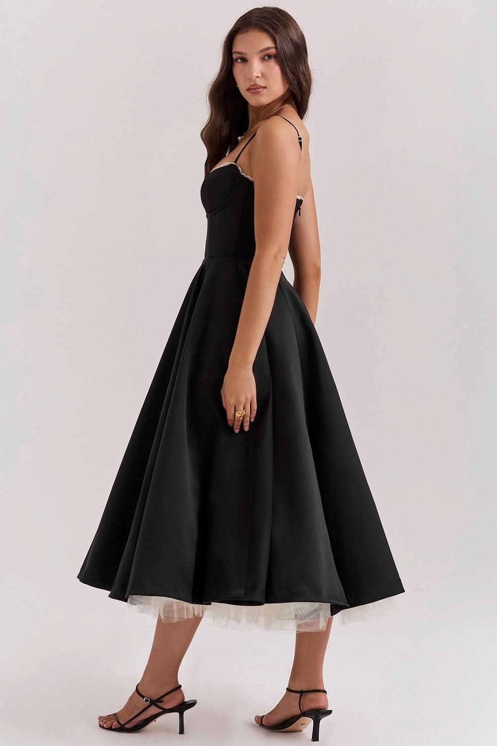 Back view of black midi dress showing open back and flowing tulle skirt