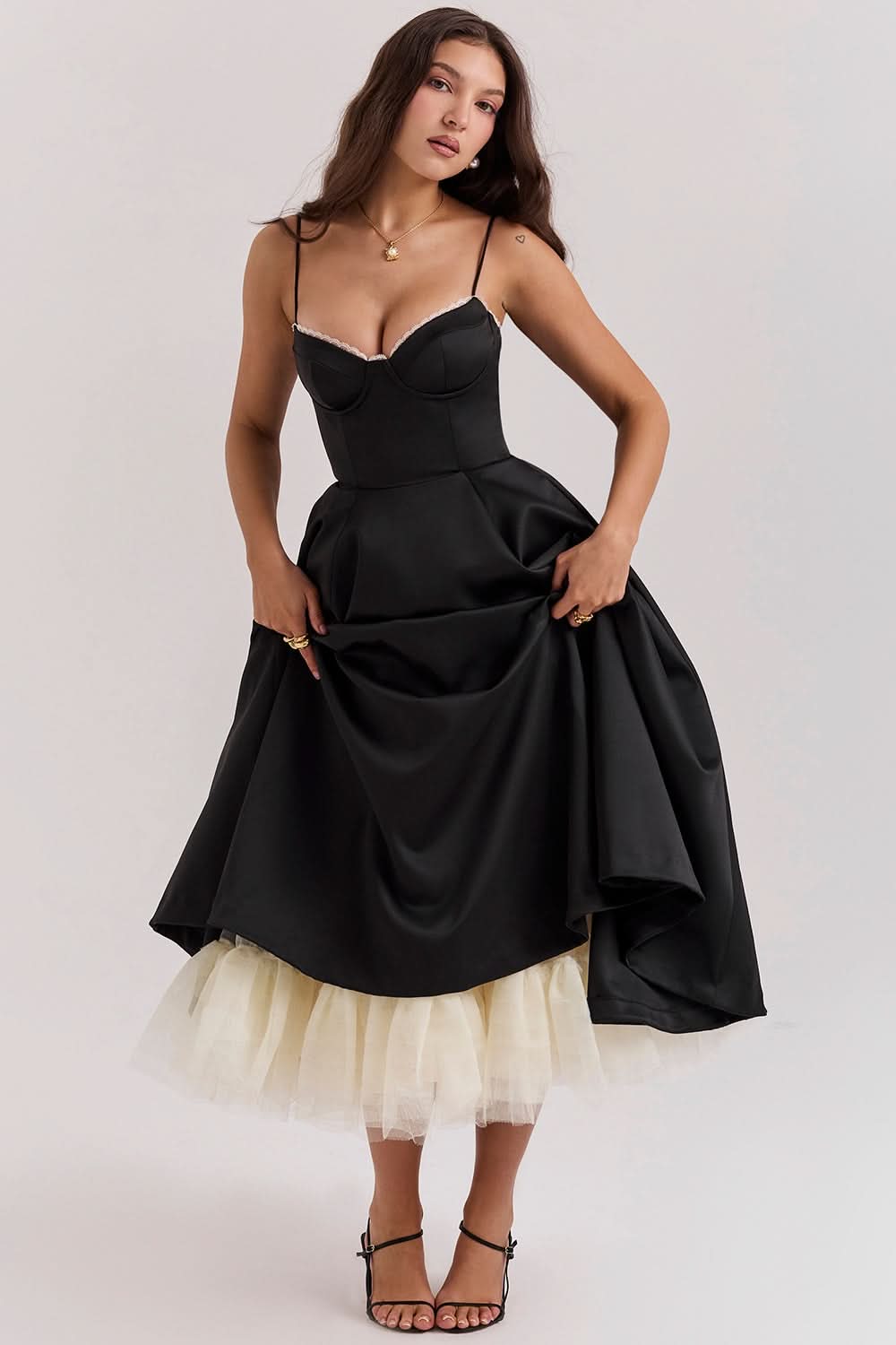 Black midi dress with structured bodice and cream tulle underskirt detail