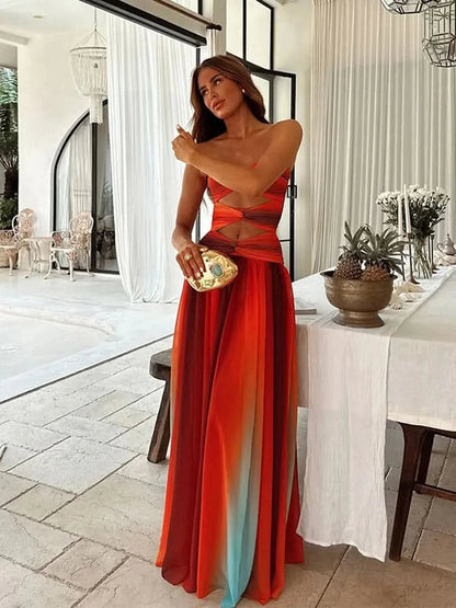 Side profile of red teal ombré maxi dress showing cut-out detail and flowing skirt for women