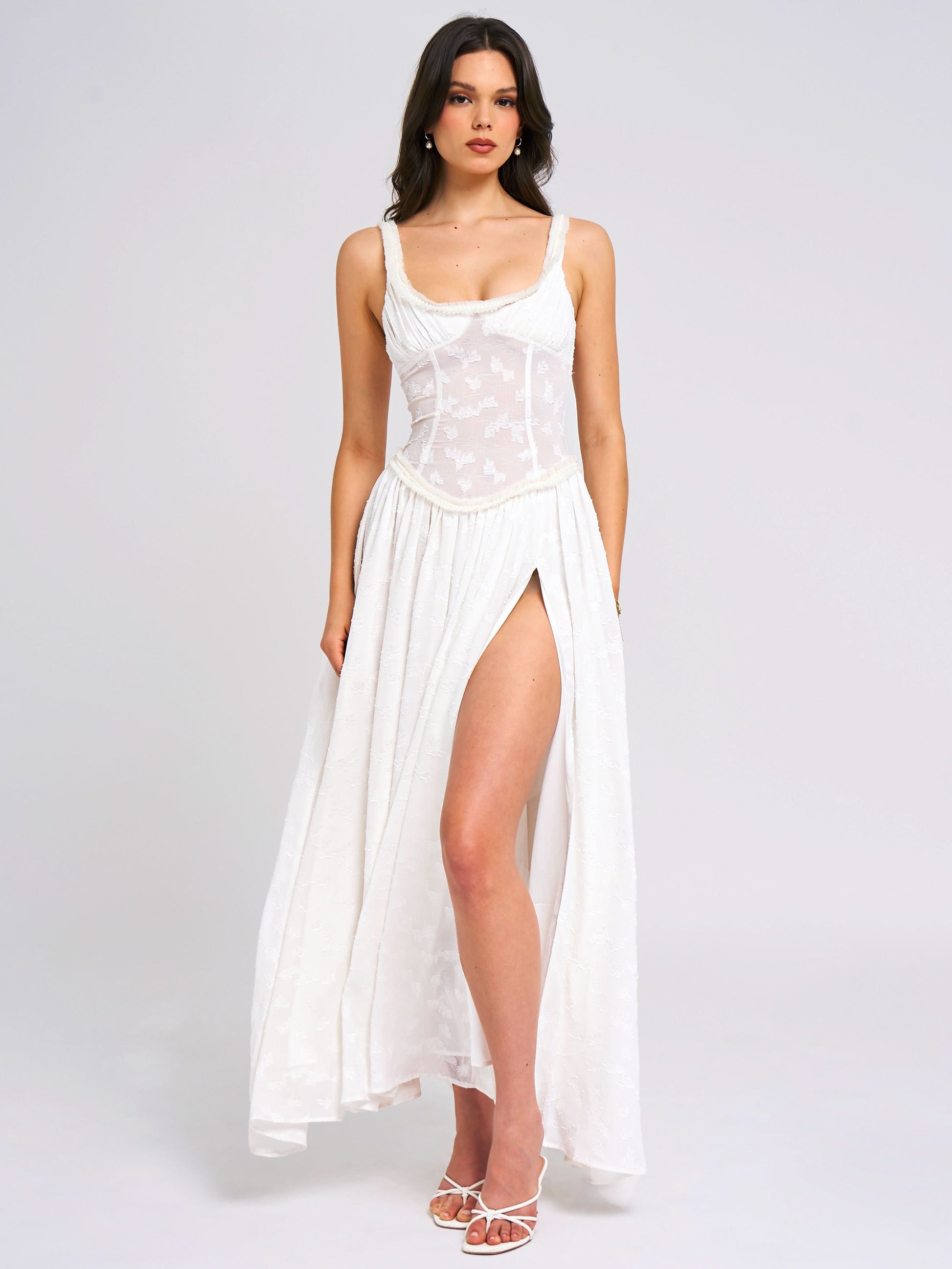 White sleeveless maxi dress with embroidered corset top and high leg slit