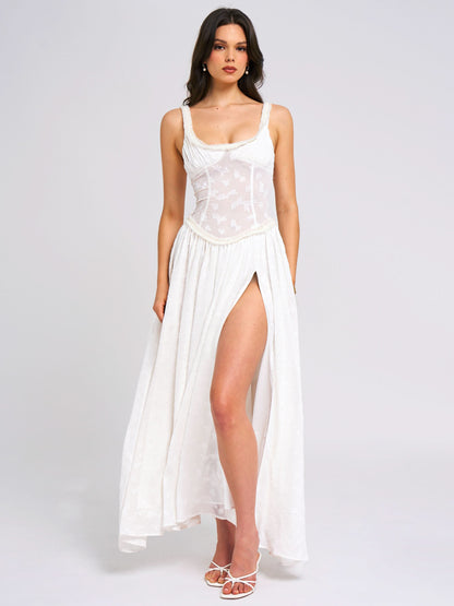 White sleeveless maxi dress with embroidered corset top and high leg slit