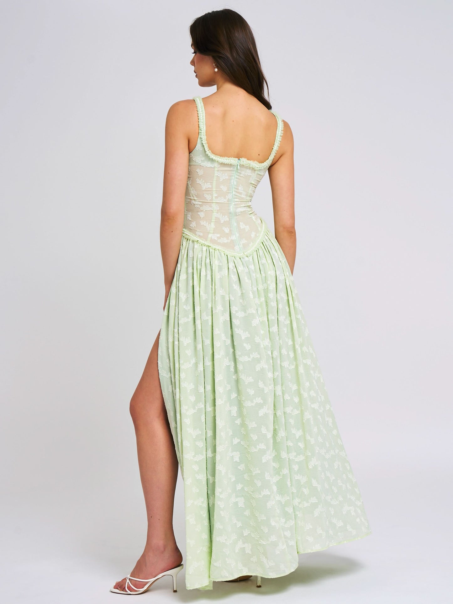Back view of green maxi dress showing corset lacing detail