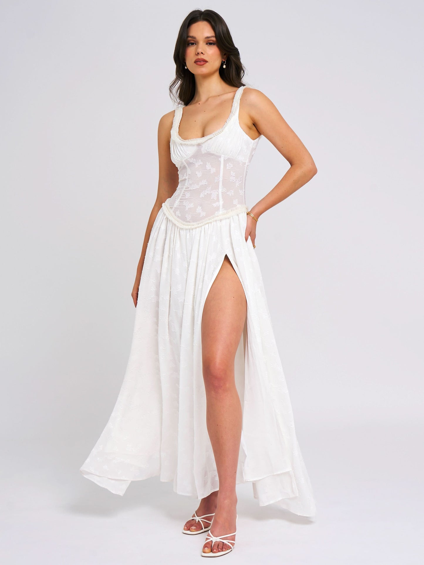 Cream maxi dress with structured corset and pleated skirt slit