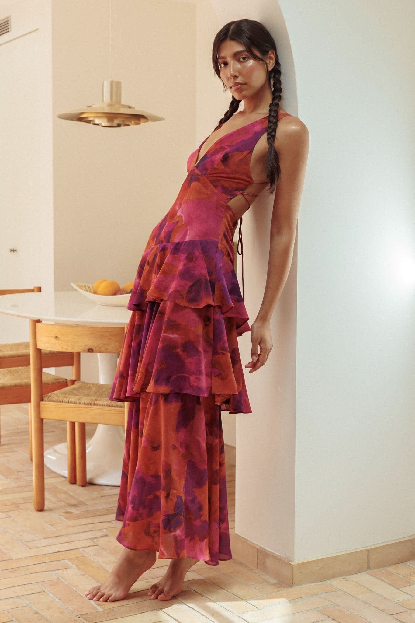 Side view of red tie-dye ruffle midi dress showing layered ruffled skirt detail