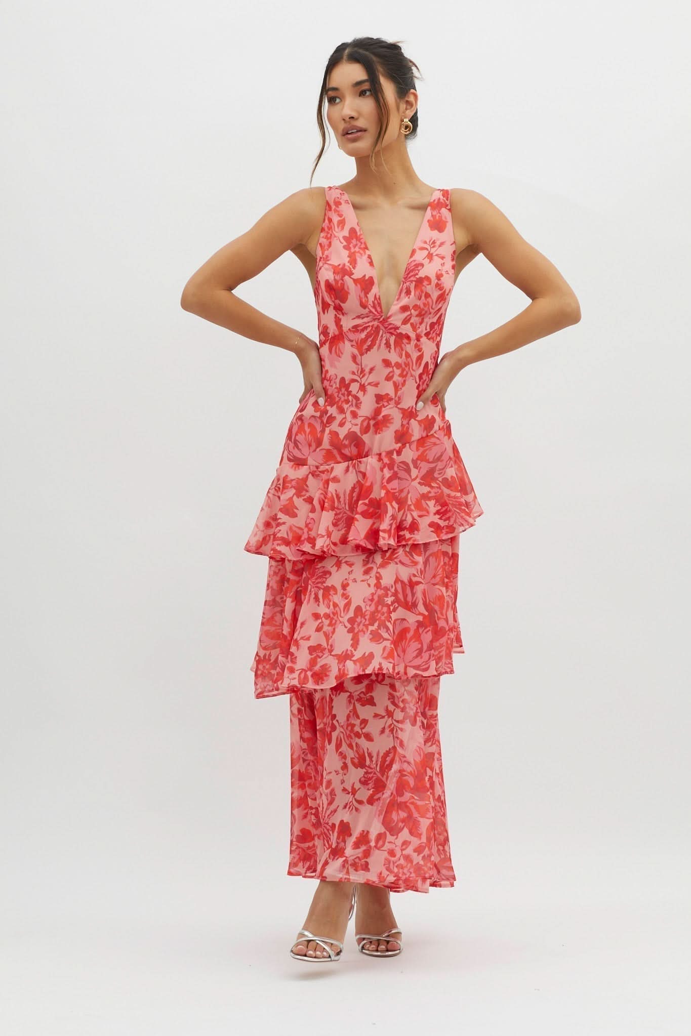 Front view of coral floral ruffle midi dress with layered skirt detail